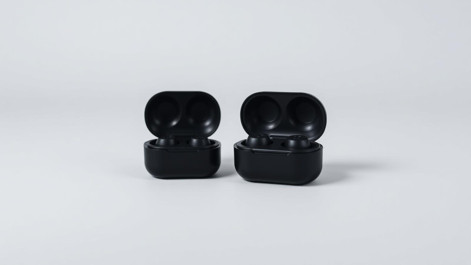 True wireless earbuds beside their charging case
